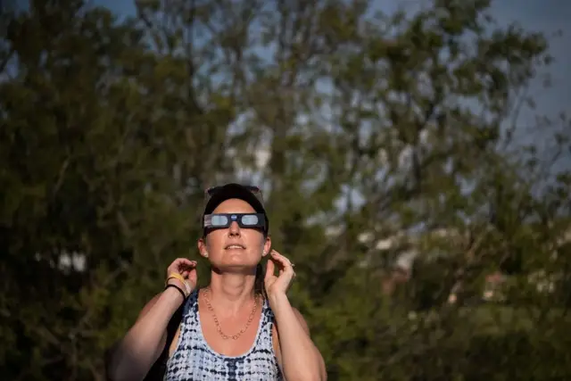 Dana Hamerschlag tests out a pair of eclipse glasses at the South Carolina State Museum August 20, 2017 in Columbia, South Carolina